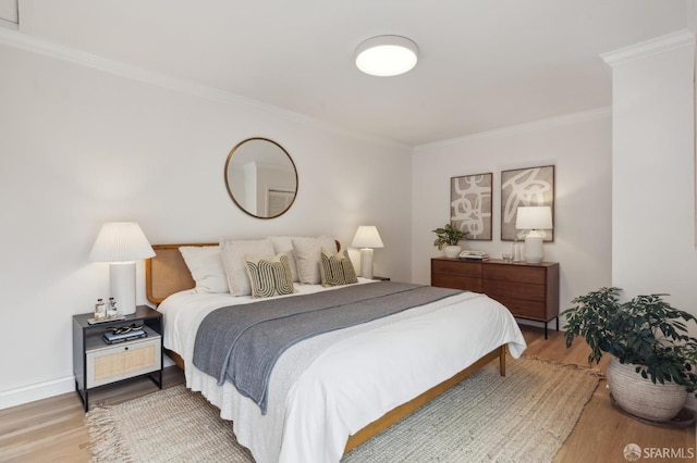 bedroom with crown molding and hardwood / wood-style flooring