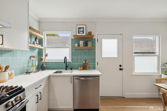 kitchen with crown molding, appliances with stainless steel finishes, sink, and white cabinets