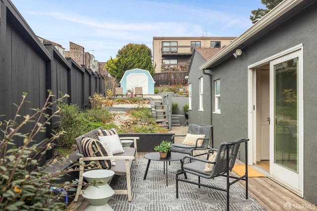 view of patio / terrace featuring a storage shed and an outdoor living space