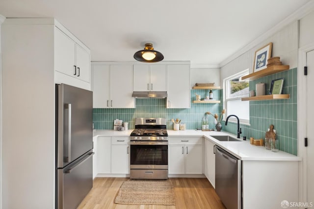 kitchen featuring tasteful backsplash, appliances with stainless steel finishes, sink, and white cabinets