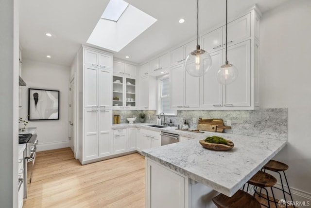 267 Bonview St, San Francisco, CA 94110 - kitchen with white cabinetry, decorative backsplash, stainless steel appliances, a peninsula, and recessed lighting