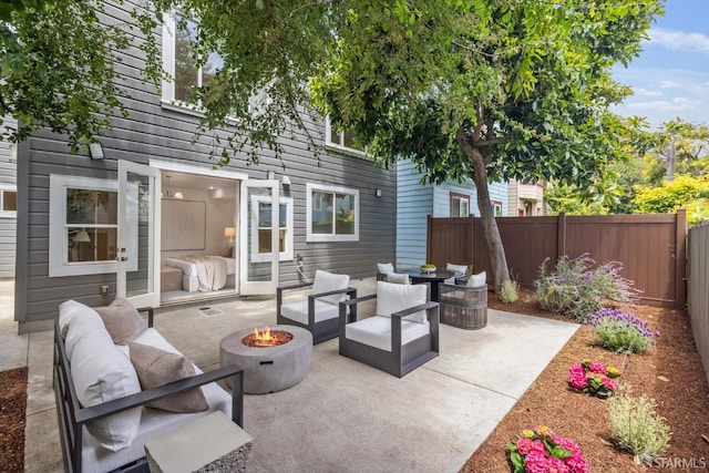 267 Bonview St, San Francisco, CA 94110 - fenced backyard with an outdoor living space with a fire pit and a patio