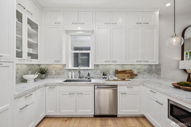 267 Bonview St, San Francisco, CA 94110 - kitchen featuring appliances with stainless steel finishes, white cabinets, decorative backsplash, and light stone counters