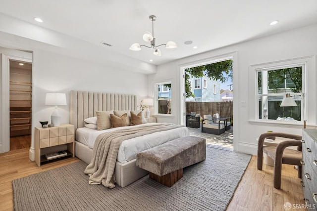 267 Bonview St, San Francisco, CA 94110 - bedroom with access to outside, a chandelier, wood finished floors, and recessed lighting