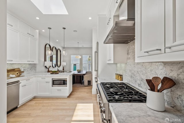 267 Bonview St, San Francisco, CA 94110 - kitchen with wall chimney exhaust hood, appliances with stainless steel finishes, white cabinets, and recessed lighting