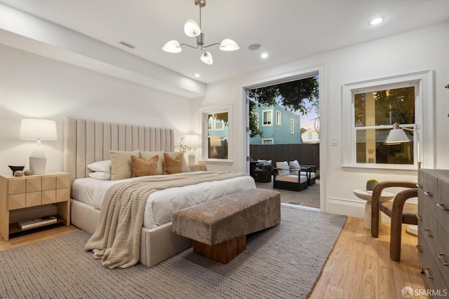 267 Bonview St, San Francisco, CA 94110 - bedroom with light wood-type flooring, a chandelier, access to outside, and recessed lighting
