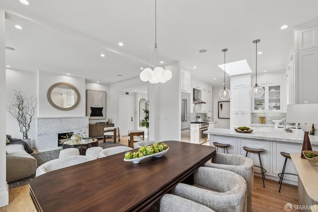 267 Bonview St, San Francisco, CA 94110 - dining space with light wood-type flooring, recessed lighting, and a premium fireplace