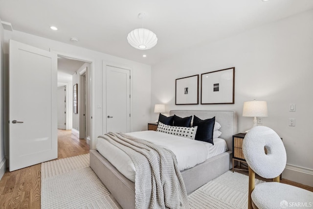 267 Bonview St, San Francisco, CA 94110 - bedroom with light wood-style floors and recessed lighting