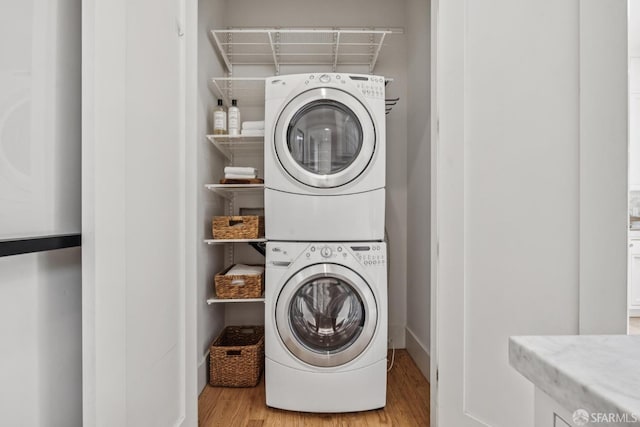 267 Bonview St, San Francisco, CA 94110 - washroom featuring stacked washer and clothes dryer and wood finished floors