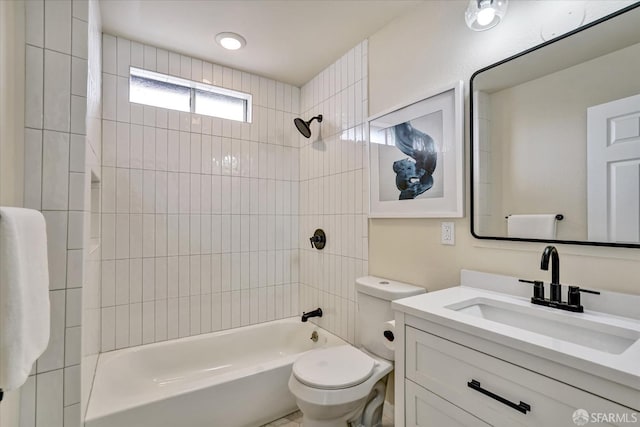 full bathroom with vanity, tiled shower / bath combo, and toilet