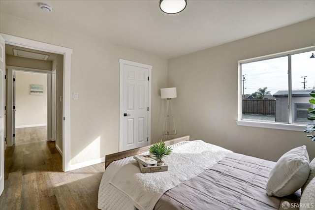 bedroom with hardwood / wood-style floors