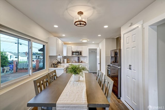 dining space featuring dark hardwood / wood-style floors and sink