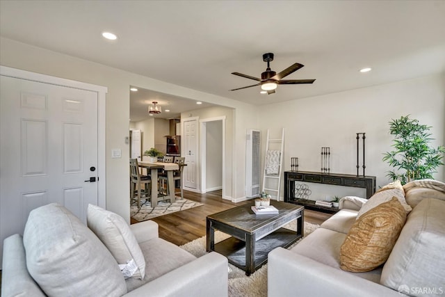 living room with hardwood / wood-style flooring and ceiling fan