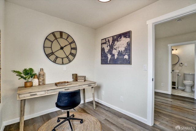 home office with dark hardwood / wood-style flooring