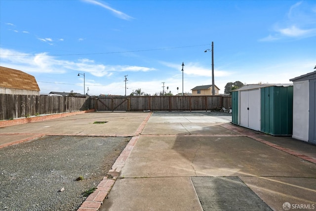 view of yard featuring a patio and a storage shed