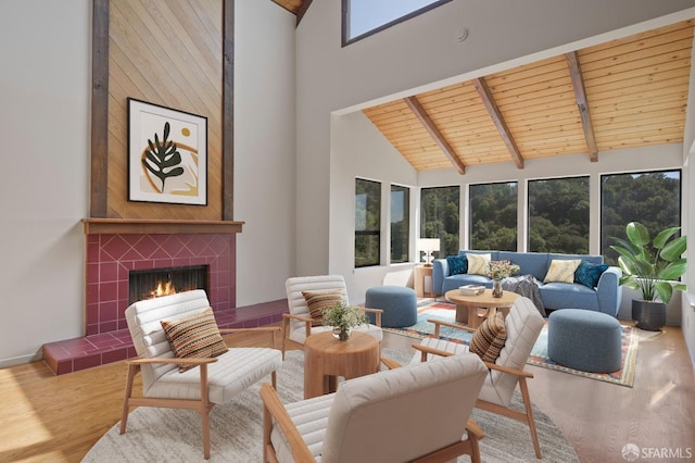 living room with beamed ceiling, high vaulted ceiling, wood ceiling, and wood finished floors