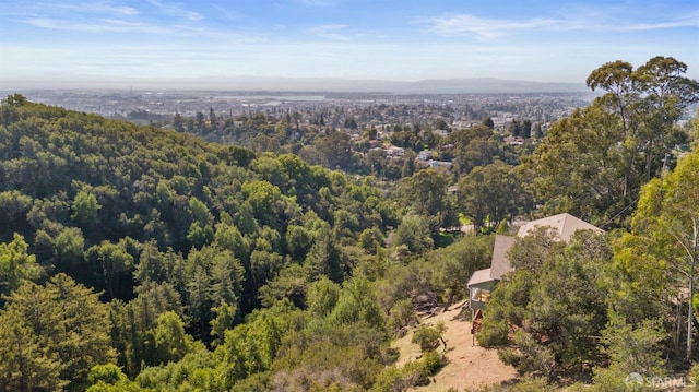 drone / aerial view with a wooded view