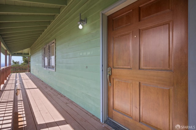 view of exterior entry with covered porch