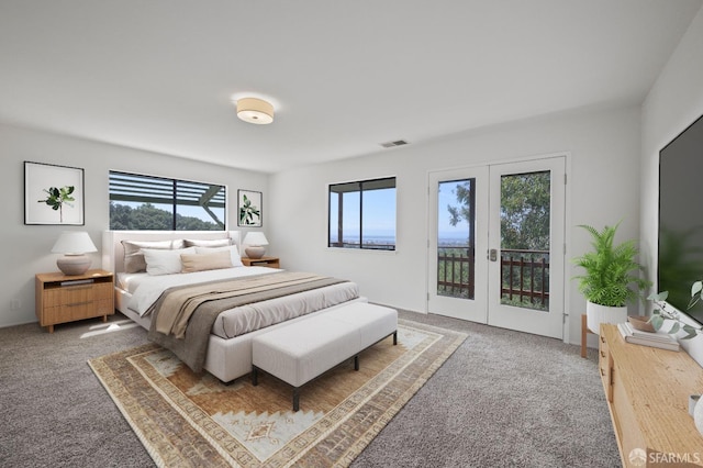 carpeted bedroom with access to exterior, visible vents, multiple windows, and french doors