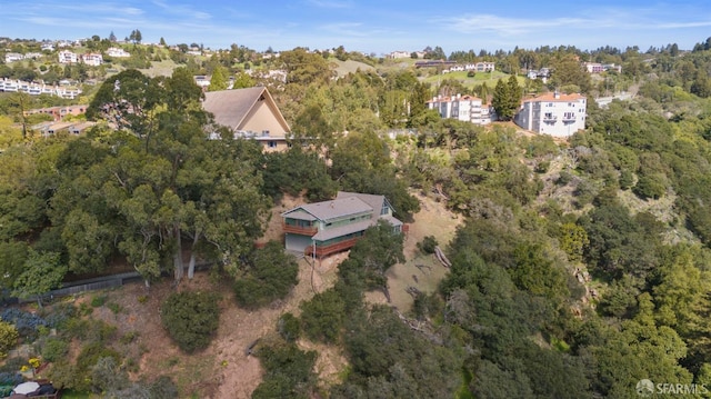 birds eye view of property with a view of trees