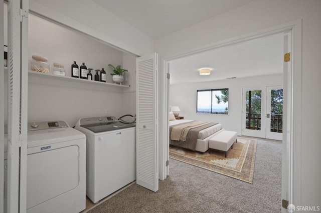 laundry room with french doors, carpet floors, laundry area, and washing machine and clothes dryer