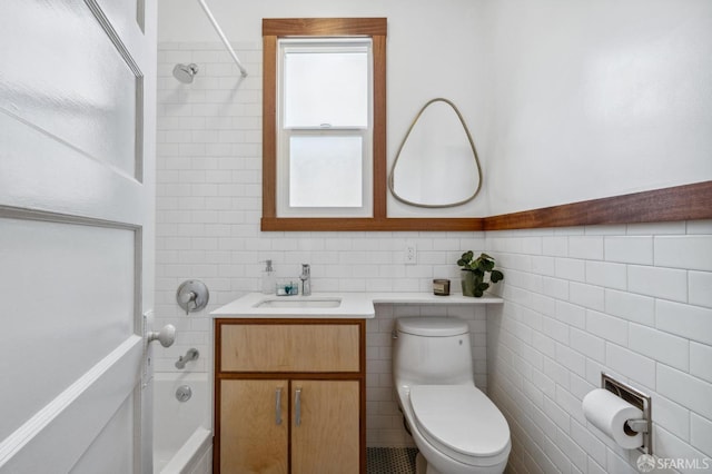 full bathroom with shower / tub combination, vanity, tile walls, and toilet