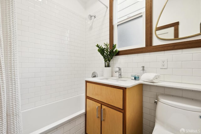 full bathroom featuring shower / bath combo, vanity, and toilet