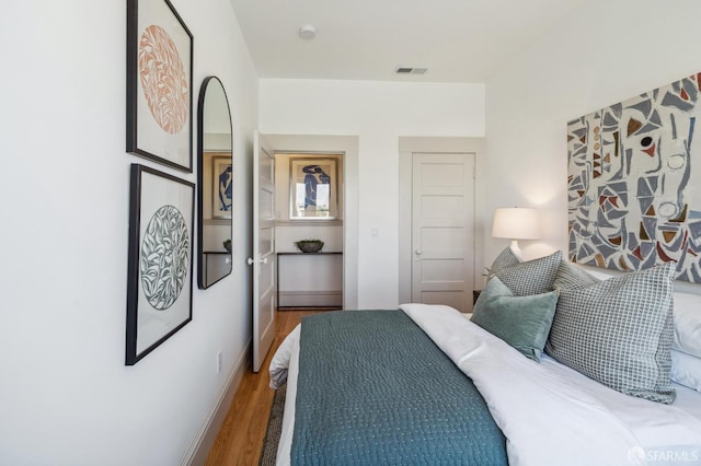 bedroom with hardwood / wood-style floors