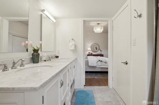 full bathroom featuring ensuite bathroom, double vanity, and a sink