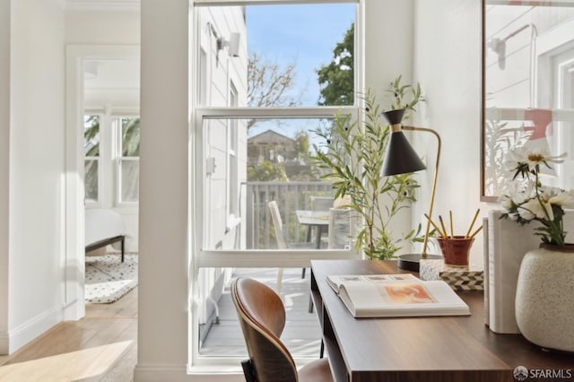 office with a healthy amount of sunlight and wood finished floors