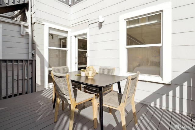 wooden terrace with outdoor dining area