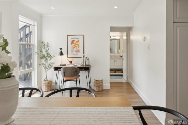 interior space with ornamental molding, recessed lighting, baseboards, and wood finished floors