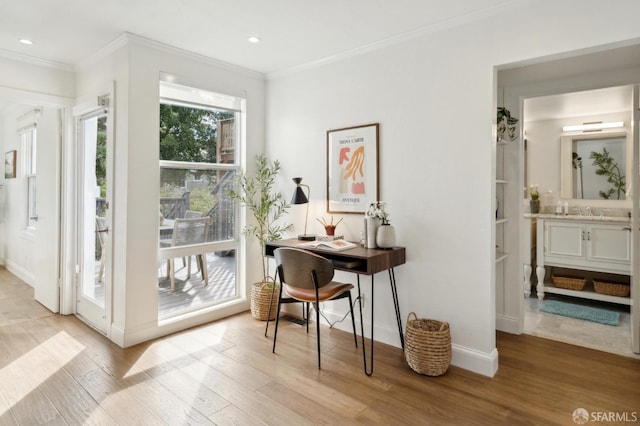 entryway featuring light wood-type flooring, baseboards, crown molding, and recessed lighting