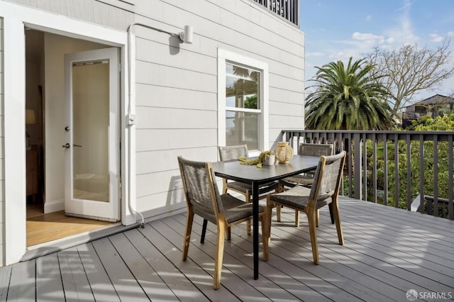 wooden deck with outdoor dining area