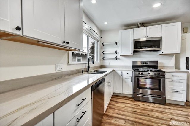 2830 Parker Ave, Oakland, CA 94605 - kitchen featuring stainless steel appliances, white cabinetry, light wood-style floors, recessed lighting, and light stone counters