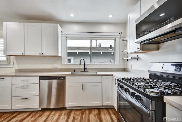 2830 Parker Ave, Oakland, CA 94605 - kitchen with appliances with stainless steel finishes, white cabinetry, light wood-style flooring, light countertops, and recessed lighting