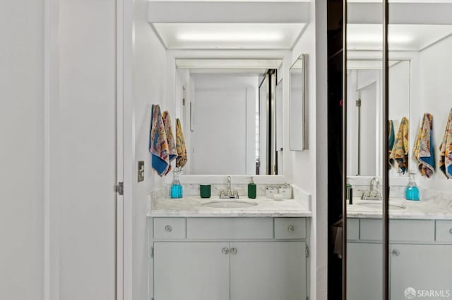 full bathroom featuring two vanities
