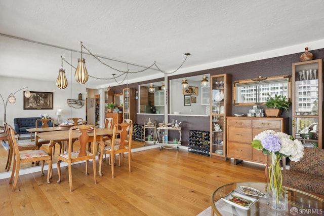 dining room featuring hardwood / wood-style flooring and a textured ceiling