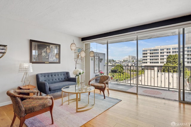 living room with wood-type flooring, a view of city, and a textured ceiling