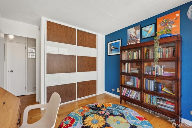 living area with wood finished floors and baseboards