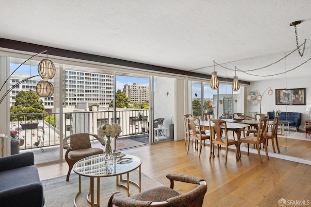living area with wood finished floors, a textured ceiling, and a city view