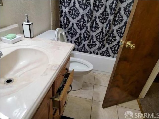 full bathroom featuring toilet, vanity, tile patterned floors, and shower / tub combo