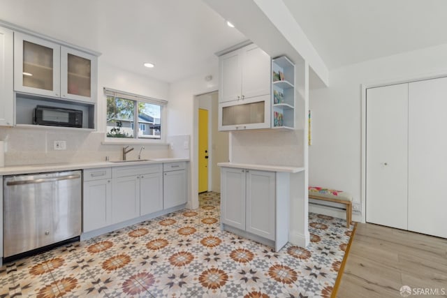 kitchen with tasteful backsplash, sink, and stainless steel dishwasher