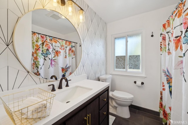 bathroom with tile patterned floors, vanity, and toilet