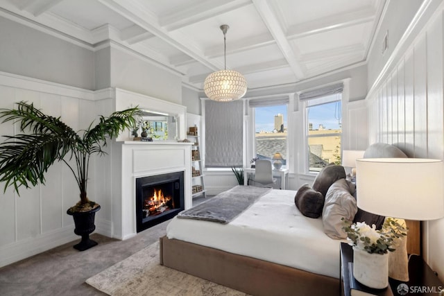 bedroom featuring coffered ceiling, a lit fireplace, carpet floors, a decorative wall, and beam ceiling