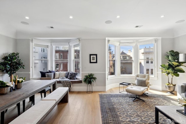 sitting room with light wood-style floors, visible vents, and recessed lighting