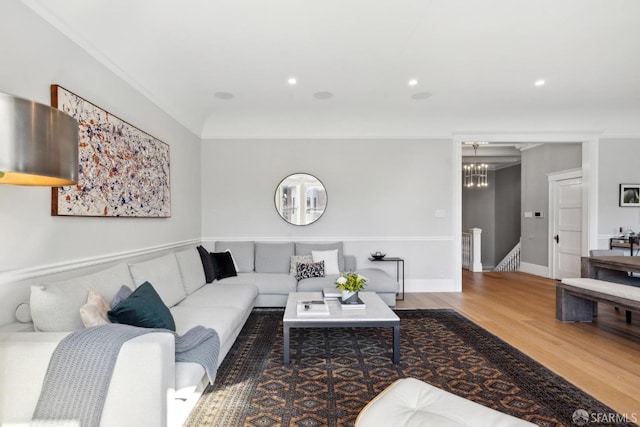 living room with recessed lighting, a notable chandelier, baseboards, and wood finished floors