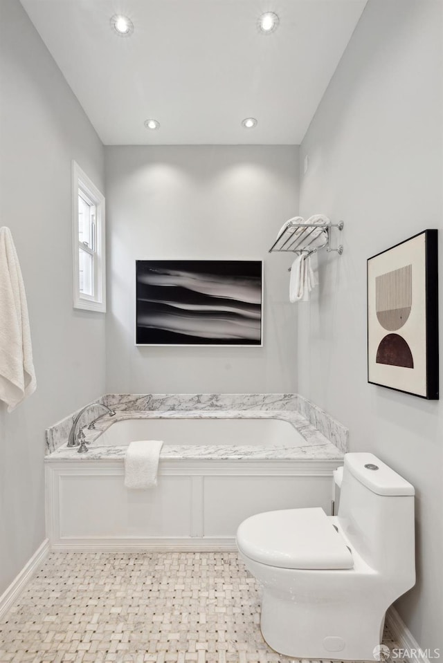 bathroom featuring toilet, baseboards, a bath, and recessed lighting