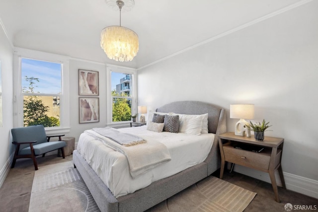 bedroom with an inviting chandelier, baseboards, crown molding, and carpet flooring