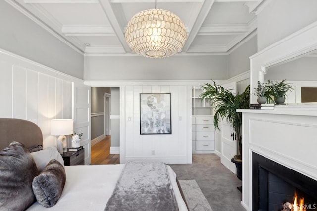 bedroom featuring a warm lit fireplace, coffered ceiling, and beamed ceiling